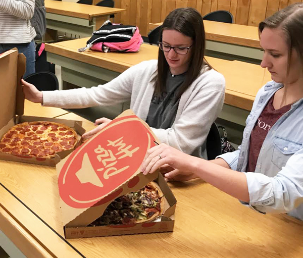 Lunch meeting--
SkillsUSA juniors Evalin Friesen and Rita Klassen get themselves pizza during a lunch meeting for SkillsUSA family consumer sciences. This is the first year for FCS to have a SkillsUSA chapter.