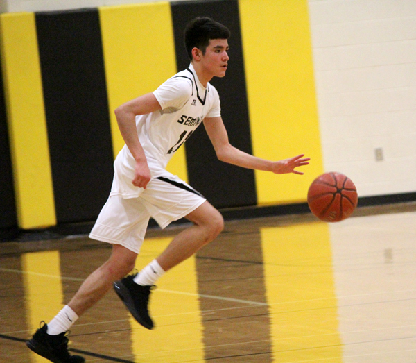 Setting it up--
Freshman Trey Villalva brings the ball downcourt during the district win over Andrews, 47-33, on Feb. 5.