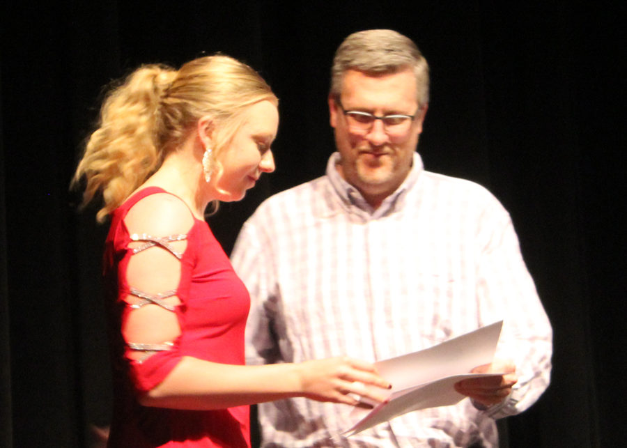 Cashing in--
Senior Brittney Weeks receives an athletic booster club scholarship from booster member Trey Duncan at the athletic awards presentation on 5-14. Weeks was one of nine seniors to receive scholarships at the event.