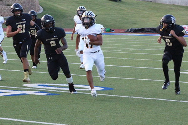 LEADING THE CHASE--Junior running back Damion Espino takes the ball downfield during the season opener in Lubbock on Aug. 29. Espino scored the first touchdown of the 57-7 win over the Westerners.