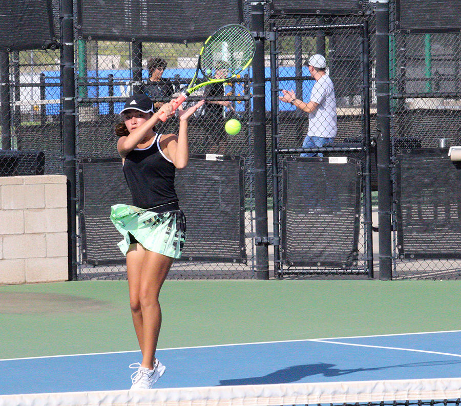 ADDING UP WINS--
Firing back a volley, sophomore Alyssa Gonzales and partner senior Jasmin Klassen take out the Andrews team of Aimee Mora and Mia Martinez during district play on Oct. 1. The 6-2, 6-3 win was one of 10 wins that day to clench the historic team tennis win.