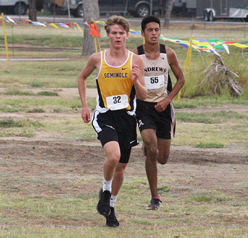 THREE-PEAT--
Edging in front of an Andrews runner, junior Micah Smith completes the first mile of three at the district meet in Pecos on Oct. 14. In eighth, Smith qualified for a third straight year for regionals.
