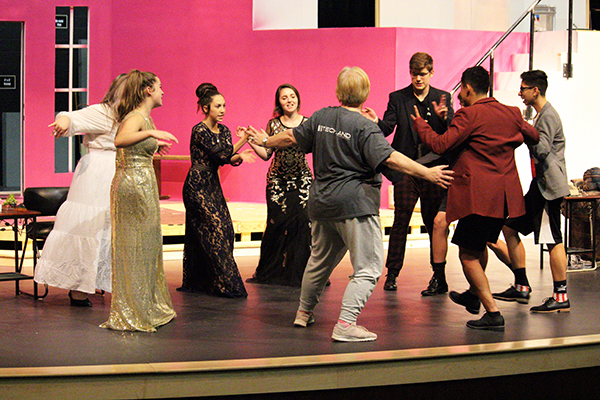 DRAMATIC WARM UP--
Theater teacher Vonya Eudy warms up the cast of Rumors before practice on Sept. 30. The play will present three performances in the PAC.