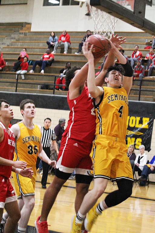 Throwback throwdown--
Under pressure, junior post Caden Cottrell is fouled from behind during preseason play with Odessa High on Jan. 10. Cottrell had 16 points as the Indians took the 74-58 win over the Bronchos in a game played in the old junior high gym as part of the throwback night honoring past Indian teams.