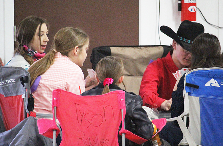 Killing time--
Senior Taylor Carlisle, sophomore Zoee Nolen and senior Jerry Knelsen join a friendly card game while waiting between events at the Gaines County Livestock Show.