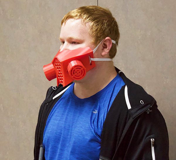 Mask maker
senior Justin Knelsen wears a mask he made with his 3D printer during quarantine. Knelsen now sells his homemade masks.