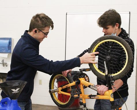 Revamping a donation--
SkillsUSA junior David Koethler and senior Benny Hildebrand work on a bicycle during fourth period auto tech class. The group’s “Give a Child a Smile” project took donations of bicycles and money to provide new and refurbished bikes to local children. 