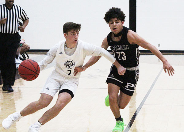 Moving the ball--
Senior guard Kross Carter moves past a Permian defender during preseason play on Dec. 12. The Indians defeated the Panthers, 74-45, on the Seminole court. 