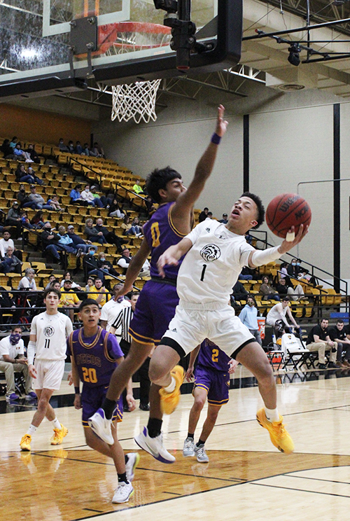 Contortionist--
Senior guard Eli Beard maneuvers around a Pecos player during the 88-21 district win over the Eagles on Feb. 9. Beard finished the game with 24 points, three rebounds, three assists and three steals. 
 Penelopi Neudorf