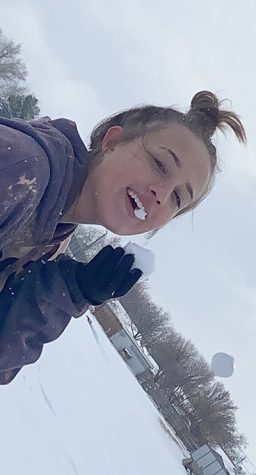 Fun frolic--Sophomore Emily Archer gets a taste of snow on Jan. 11 after Superintendent Kyle Lynch called off school.

“I’ve always loved going to play in the snow. Something about it always makes it look so magical,” Archer said.