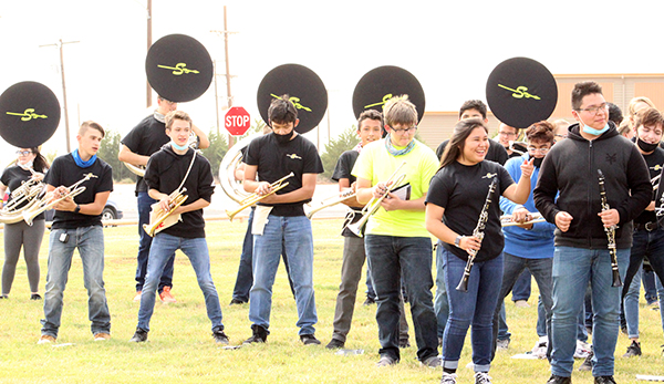 Feel the rhythm--
Pride of the Tribe moves with the cadence as it  braves grass burrs a the homecoming pep rally on Sept. 18.