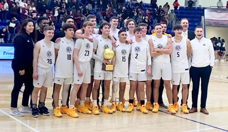 Region+quarterfinal+champs--The+Indian+basketball+team+celebrates+with+a+trophy+after+defeating+Hereford%2C+71-64%2C+on+Feb.+27+in+Lubbock.