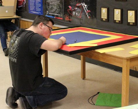 Beginning the process--
Auto Tech SkillsUSA junior Dylan Klassen works on the chapters bulletin board for competition in October. Klassen, juniors Korbin Lambert and Luzelena Perez took the gold in the district competition in February to qualify for state in April.