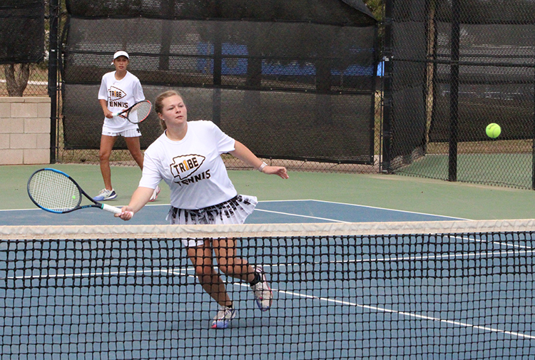 Net ball--Senior Lauren Smith goes for the return as she and partner senior Marcela Guevara compete in district on the home courts on April 16. The pair would defeat Andrews for the championship in womens doubles.