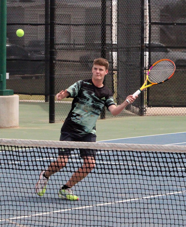 Taking aim--Sophomore Ruger Scott keeps his eye on the ball during district play on April 16. Scott and partner senior James Giesbrecht took second in mens doubles to advance to regionals.