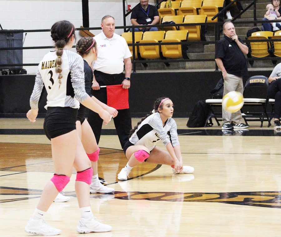 Dig it--Senior defensive specialist Brooklyn Bates digs an Andrews serve during district play on Oct. 2. The Maidens defeated the Lady Mustangs in three sets.
