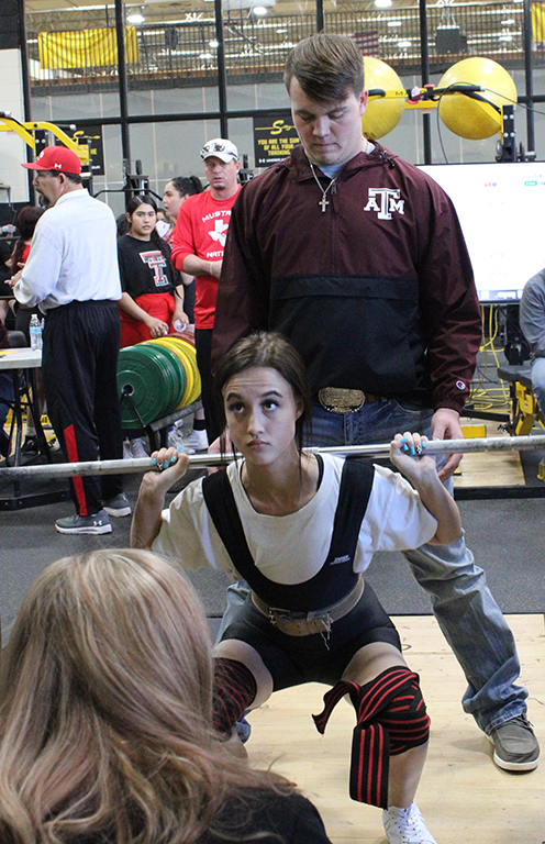 Concentration--Junior Emily Archer squats 135 pounds on her way to first place in the 114-pound division on Jan. 13. Archers combined events totaled 350 pounds.