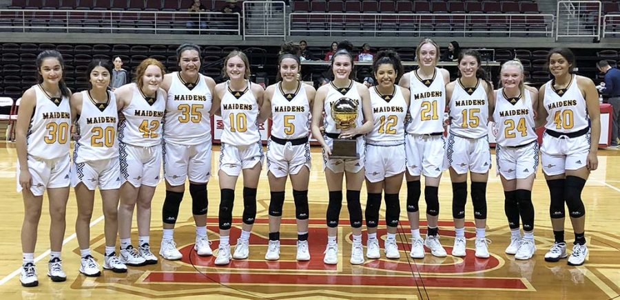 Bi-district champions--Maiden basketball players pose with the trophy after defeating El Paso Riverside, 84-36, in bi-district action in Alpine on Feb. 14.