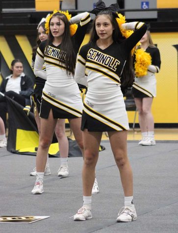 Showcasing routine--Cheerleaders junior Aeriana Langley and sophomore Mia Alvidrez perform the squads UIL competition routine at the basketball pep rally on Jan. 28. Tryouts for next years squad is scheduled for March 3.