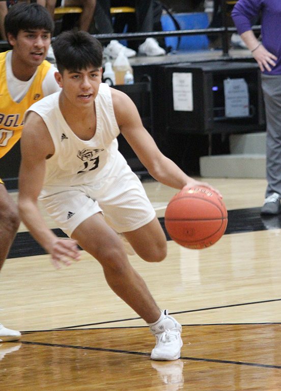 Making a move--Junior guard Hector Contreras drives into the lane during district play with Pecos on Jan. 25. Contreras had five points in the Indian victory.