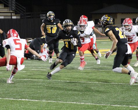Through the gap--Senior running back Nate Leyva threads the needle for more yardage during district play against Perryton on Oct. 29. The Indians would defeat the Rangers, 49-42.