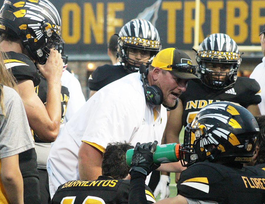 Huddle up--Defensive Coordinator John Richmond talks to the defense during preseason play against Monahans on Oct. 1. Coach Richmond is my mentor, senior linebacker Sloan Rowland said. He pushed me every single day to become better.