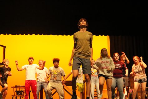 Making music--Junior Daniel Lapusan leads a dance number in Godspell rehearsals on Oct. 4. The production was postponed due to lighting outage in the performing arts center.