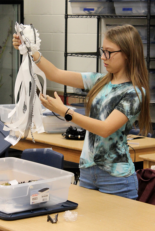 Final touches--
Floral design junior Shelby Thurmond works on a homecoming mum during fourth period on Sept. 29. FFA made and sold the mums as a fundraiser.
