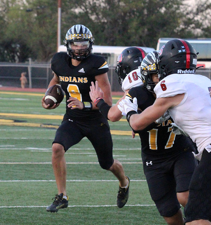 Most valuable--Senior quarterback Blake Flowers runs the ball during preseason play on Sept. 2. Flowers was chosen as the districts MVP by coaches.