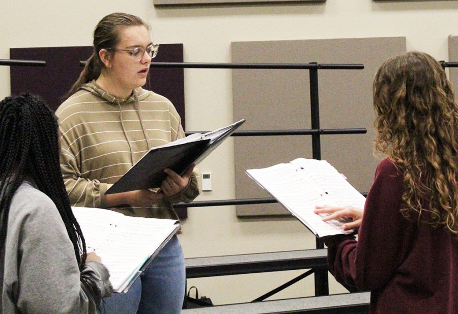 Getting+ready--senior+Olivia+Rempel%2C+junior+Angie+Klassen+Enns+and+sophomore+Lliani+Lopez+practice+area+choir+music+during+A+Cappella+on+Nov.+10.+Klassen+Enns+would+take+first+chair+in+the+alto+section.