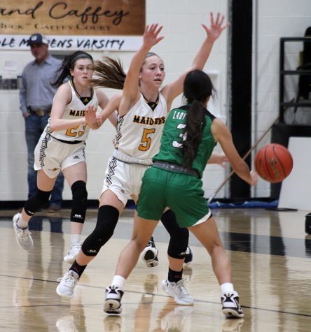 Scare tactics--
Freshman point guard Jordan Danley’s defense causes Lady Lobo Adriana Soto’s hands ripe for junior guard Londyn Shain to scoop up. Danley had eight rebounds, four steals and two assists  during the 78-22 Maiden victory on  Jan. 20.