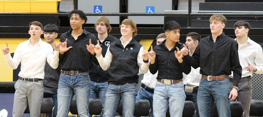 Teammates--Indian varsity players link pinkies for the school song during the basketball pep rally on Feb. 3.