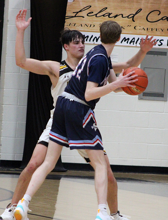 Chest up--Senior forward Blake Flowers plays defense against Greenwood on Feb. 3. Flowers had six points in the Indian loss.