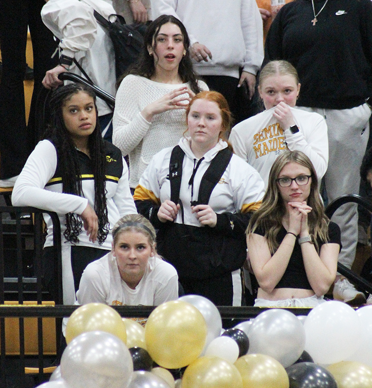 Tense moment--Students in white-out dress watch a close game in the fourth quarter as the Indians narrowly fall to Greenwood by one point on Feb. 3.