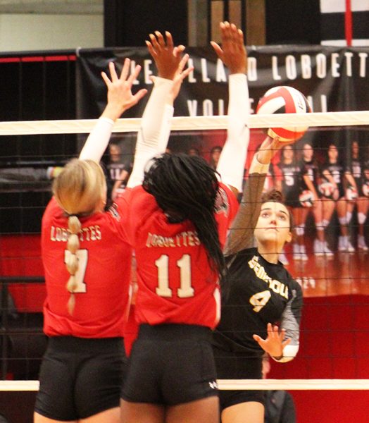Getting by--
Sophomore hitter Allison Lacy tries to get the ball past Levelland blockers during the second set on Sept. 12. The Maidens won the second set, 25-12, but lost the match in four sets.
