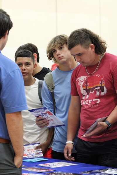 Getting the skinny--Senior Ethan Garza, junior Rowin Donaldson and senior Kevyn Duffey listen to the representative from Lubbock Christian University during college day in the upper gym. Upperclassmen were excused from eighth and ninth period to meet with college, technical school and military reps.
