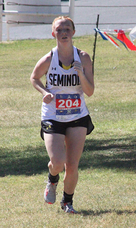 Top scorer--Freshman Addison Armstrong completes the first lap at the district race on Andrews golf course on Oct. 9. Armstrong topped all Seminole runners as she qualified for regionals in third place with a time of 13:17.30. 