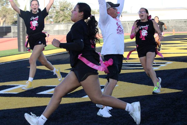 In for six--Senior quarterback Ava Olivas scores a touchdown during the first half of the powder puff game on Oct. 20.