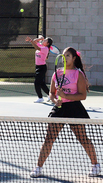 Take that--Sophomore Karolynn Caballero serves to Compasss Golden and Price during area competition on Oct. 13. Caballero and partner sophomore Melany Vazquez Campos took the match win, 6-0, 6-0.