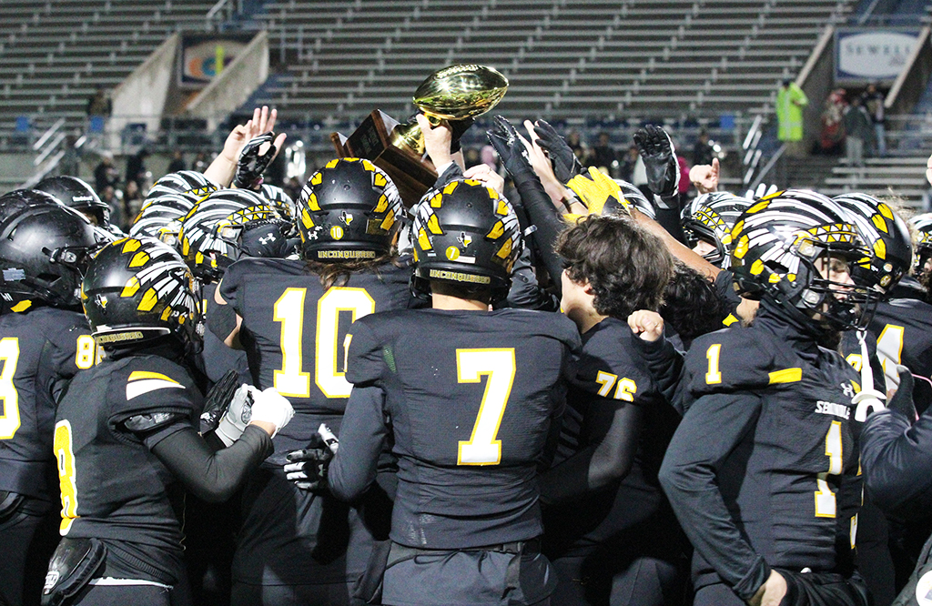 Getting the hardware--
Indian players receive the bi-district trophy on Nov. 9. The Tribe defeated Pecos, 77-14.