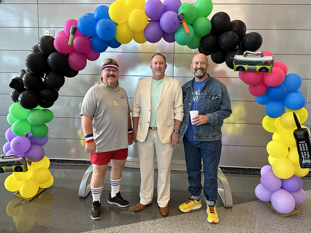 Joining in--Principal Erik Kirkpatrick gets into the retro theme with assistant principals Randy Jones and Trevor Scott during convocation inservice in August.