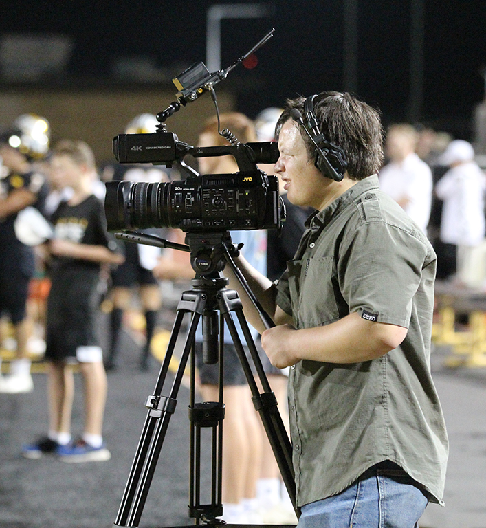 Getting the shot--Senior Austin Vanriper films during a home football game on Sept. 22. Vanripers footage from field level was fed into the video scoreboard as instant replay.