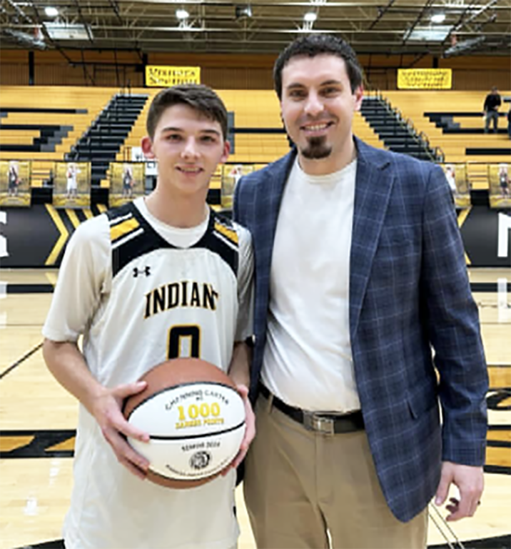 Four digit club--Senior guard Channing Carter is honored at mid court by Coach Tanner Moore in January for reaching 1,000 career points.