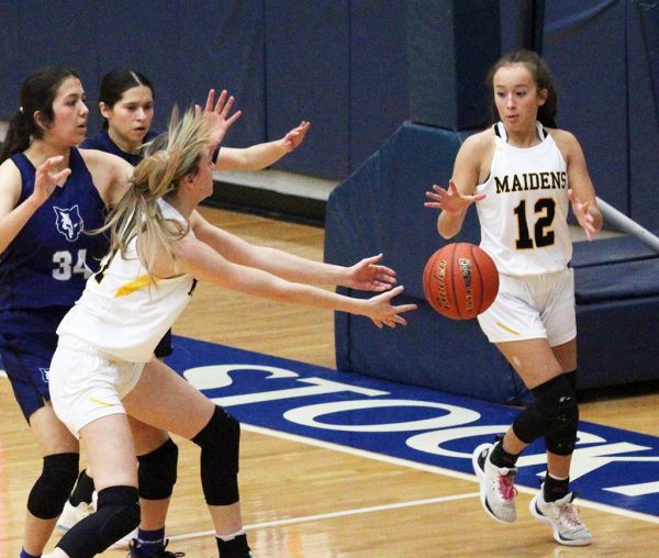 Give and go--Senior forward Tatum Medlin feeds the ball to freshman guard Miley Bates during area play versus Clint Mountain View on Feb. 15. Medlin led in assists with six.