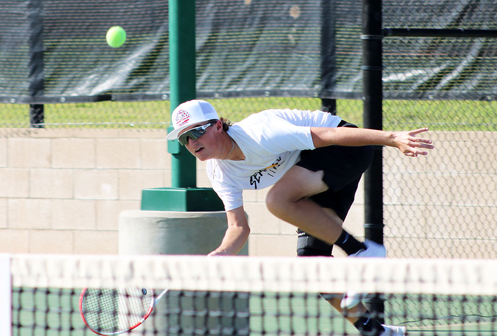 Scoop it up--Sophomore Derek Ware goes for a low ball during men's singles action with Shallowater's Cooper Bunting on Sept. 24. Ware took the 6-4, 7-5 win .