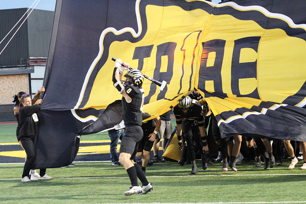 Bring the hammer down--Junior running back Caton Cramer starts the run out for the beginning of the 2024 football season on August 30.