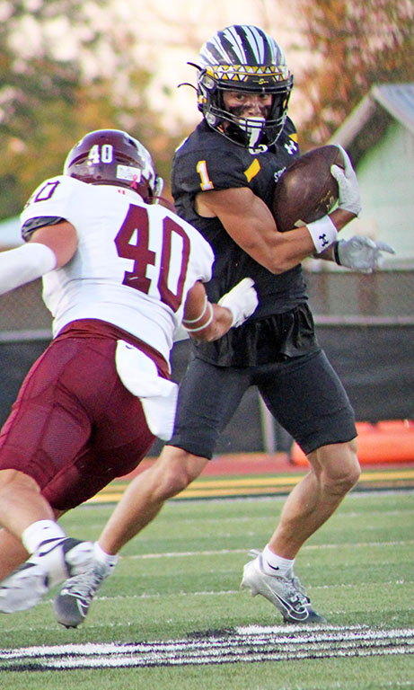 Avoiding the tackle--
Junior receiver Logan McCormick makes a move on a Hereford defender during first quarter action on Oct. 4. McCormick had nine receptions for 162 yards and two touchdowns during the Indians’ 49-17 win over the Whitefaces.