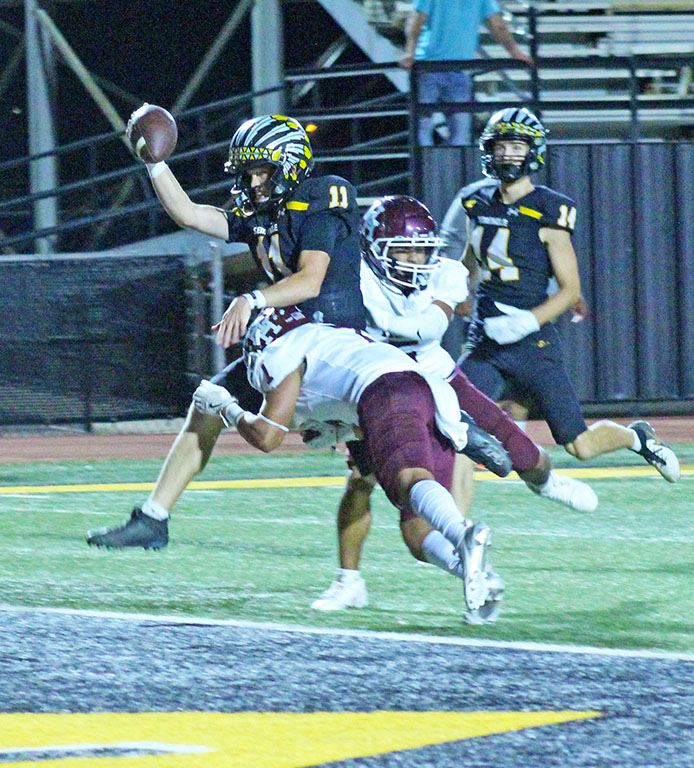 Power through--
Senior quarterback Wyatt Holmstrom pulls Hereford defenders over the goal line for a touchdown during the third quarter on Oct. 4. Holmstrom threw for five touchdowns and rushed for one during the Indian win over the Whitefaces.