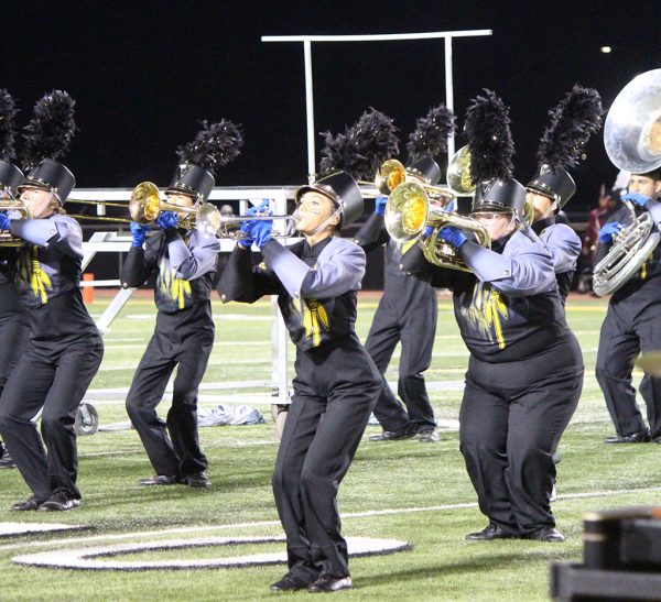 Get down--Brass section plays and moves during halftime of the football game on Oct. 4. The Pride of the Tribe competes at region contest tomorrow at 8 p.m. at Lowery Field in Lubbock.