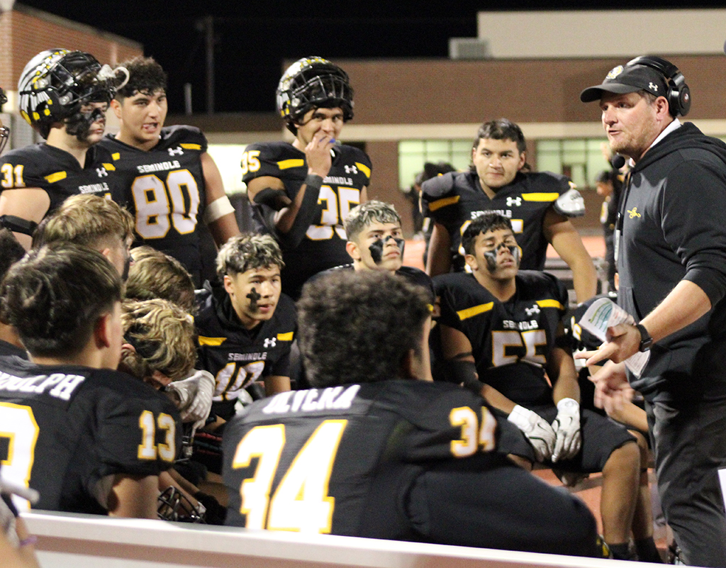 Strategy session--
Defensive Coordinator John Richmond talks to the defense during the bi-district win over Levelland on Nov. 14. Richmond said defense would be the key to defeating Glen Rose in area.